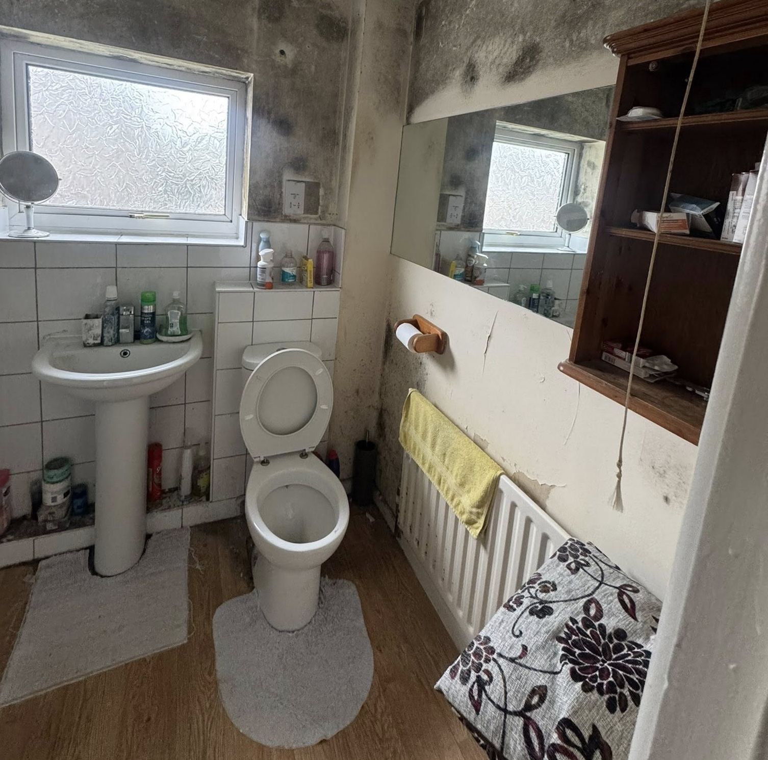 Bathroom in Woodcote property filled with tenant waste and abandoned items before clearance
