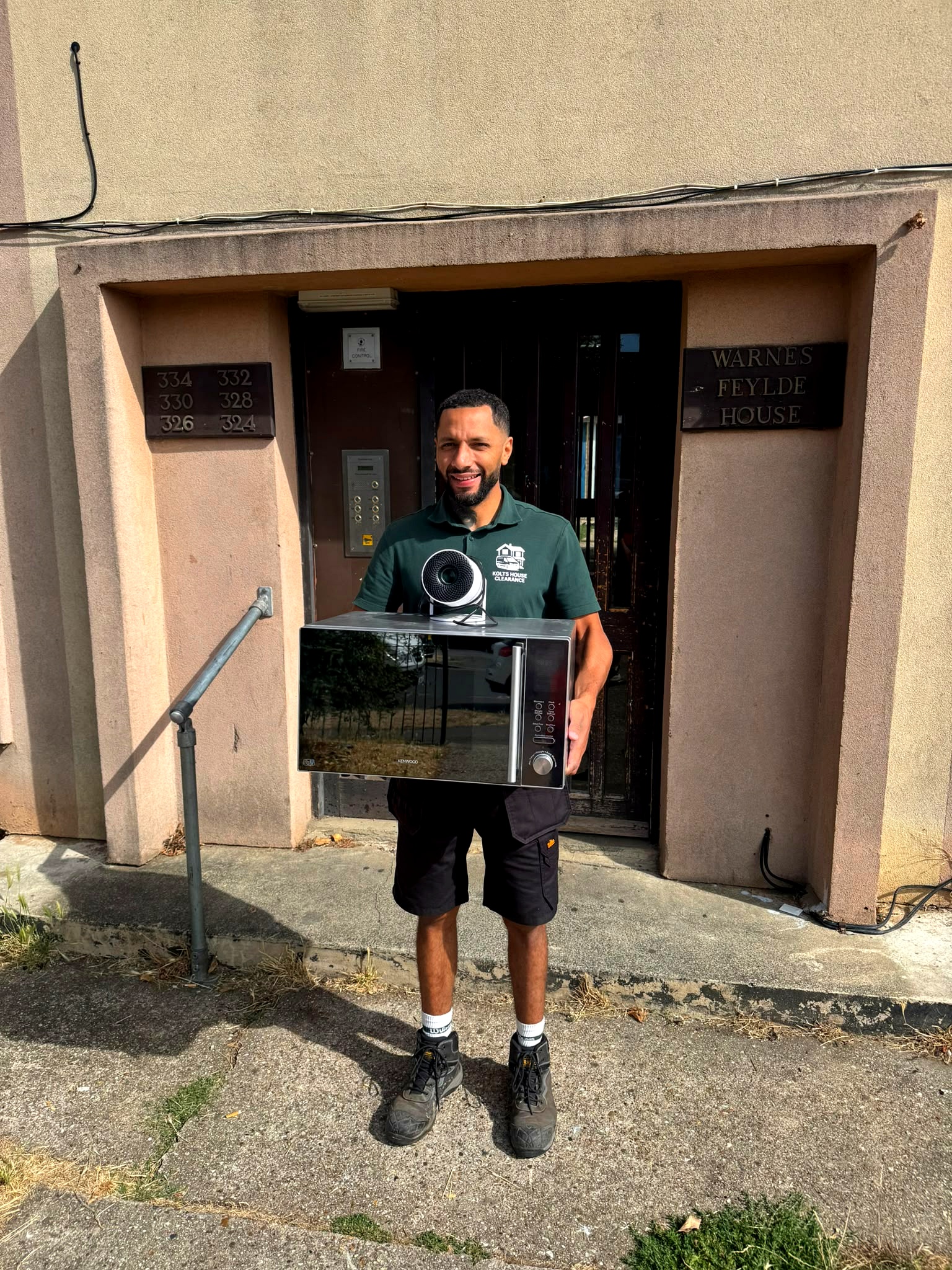 Karlton holding a microwave to give to a resident