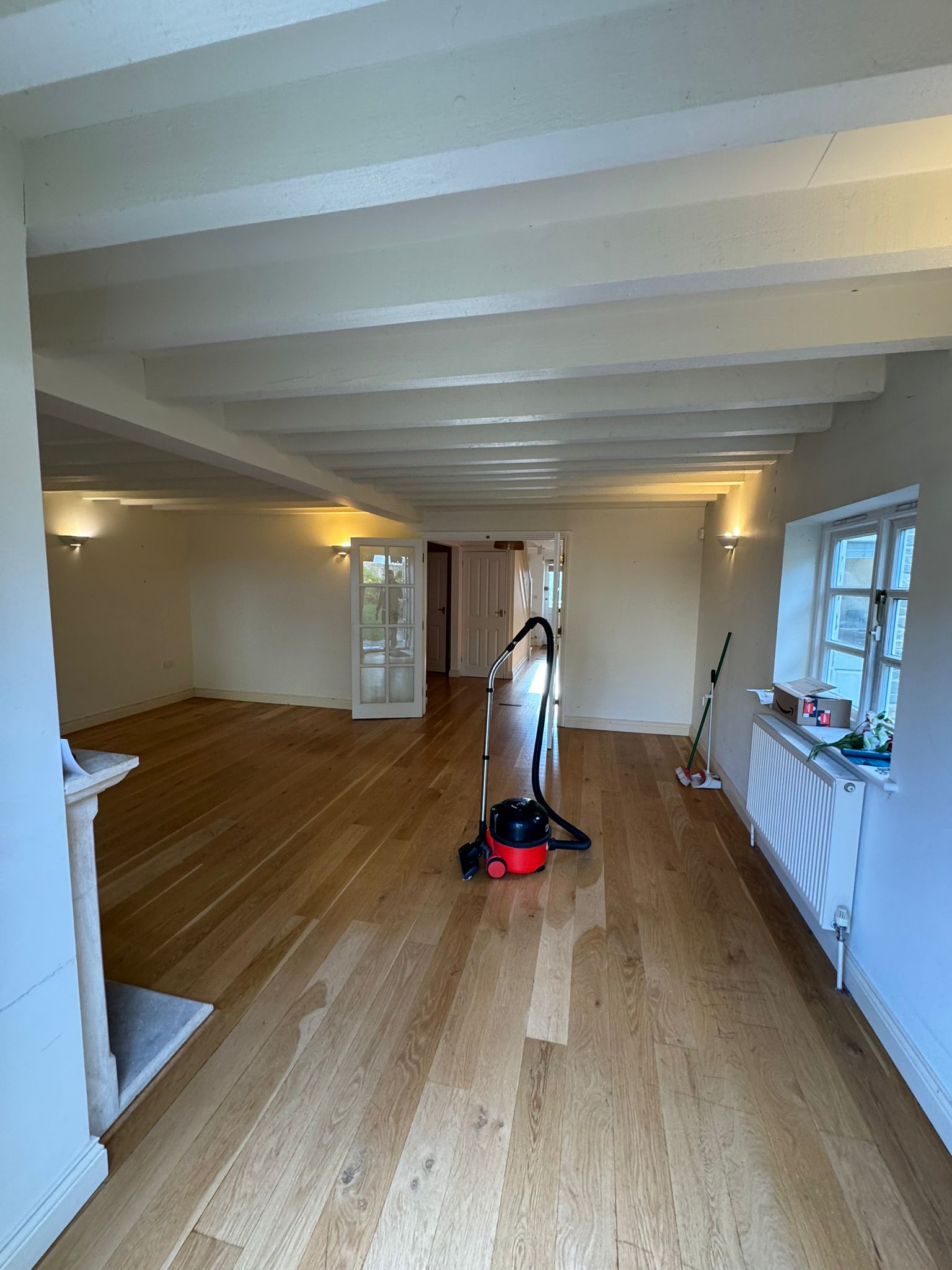cleared living room with clean wood floors