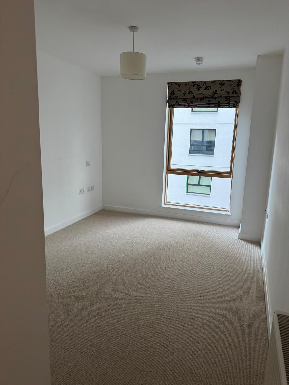 a cleared out room with carpet