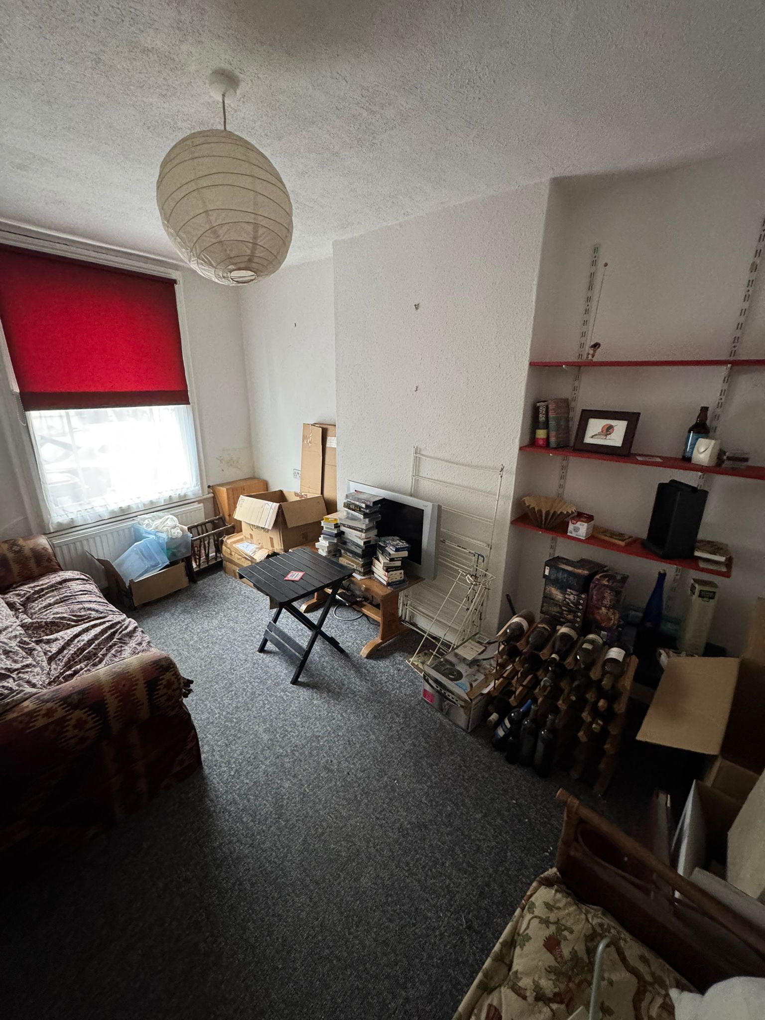 Living room filled with old furniture and carpets