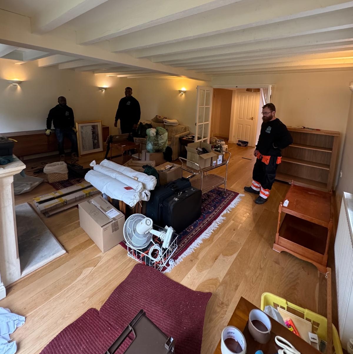 A cluttered living room before a house clearance