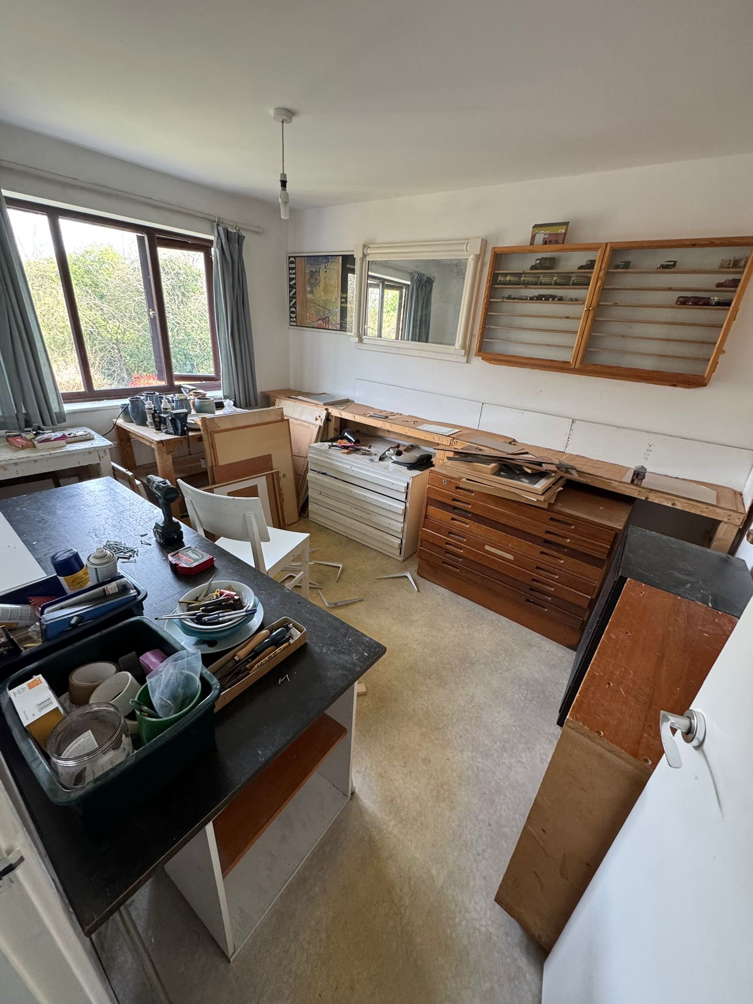 Cluttered kitchen with old appliances and waste