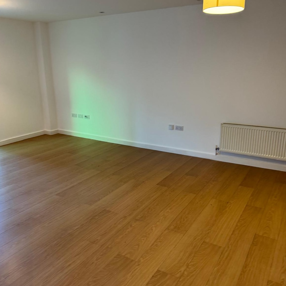 A brightly lit, spacious room with clean wooden flooring after a full house clearance in Berkshire