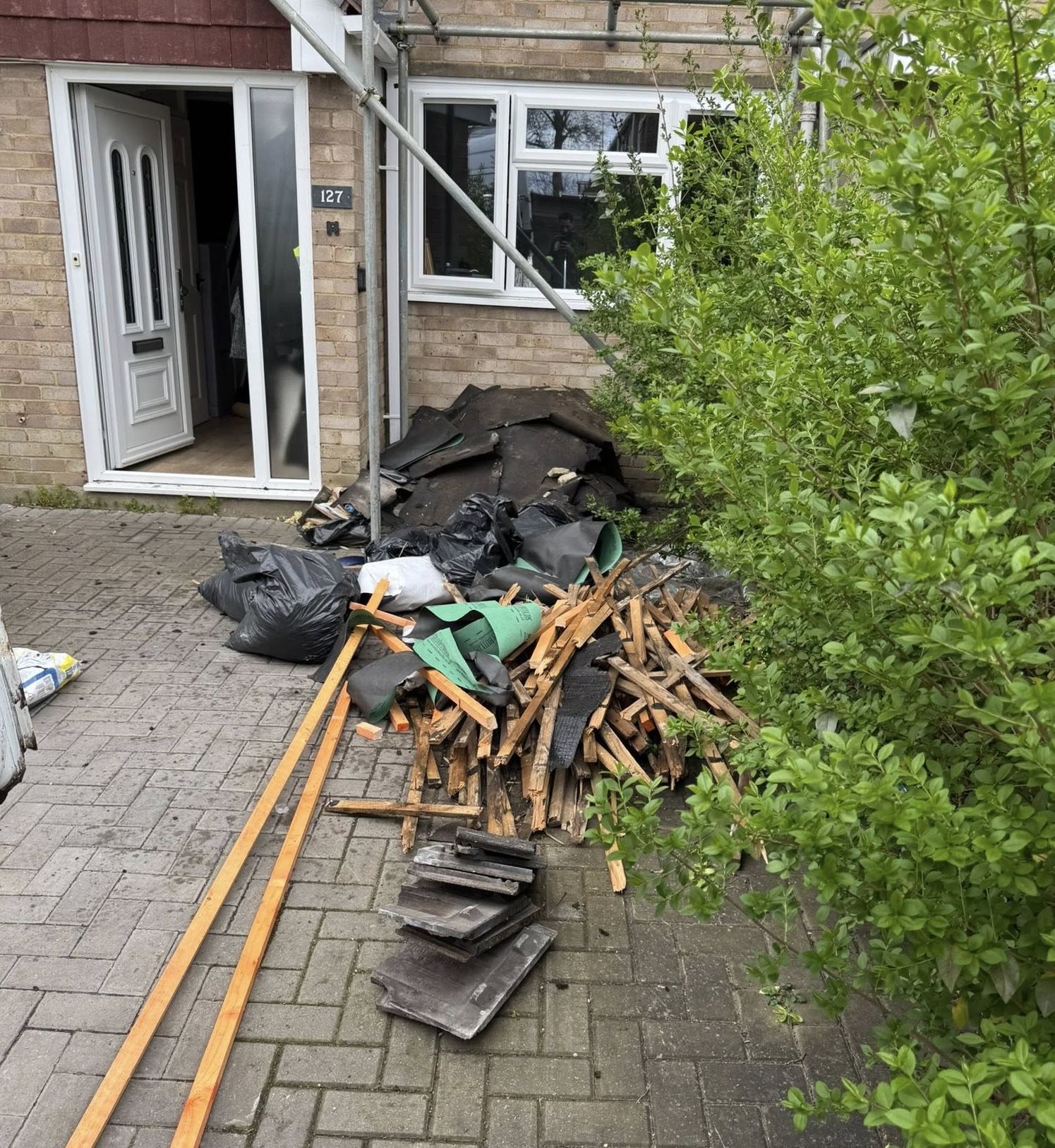 A messy patio after a roofing job.