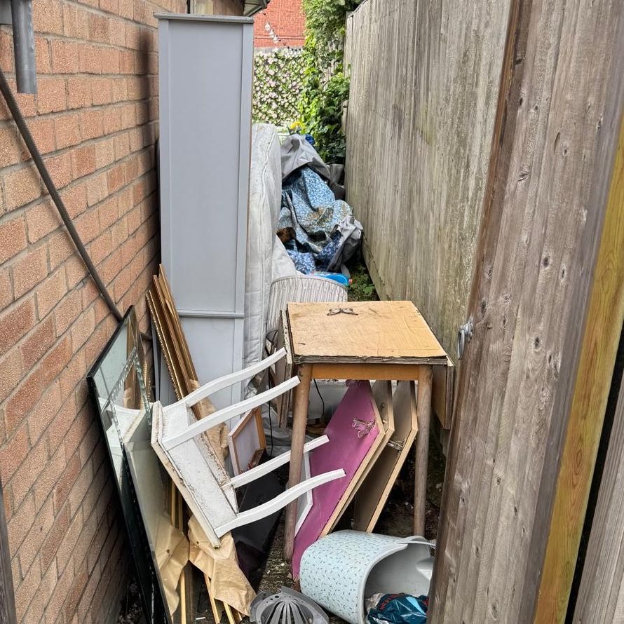 Alleyway with rubbish in it.